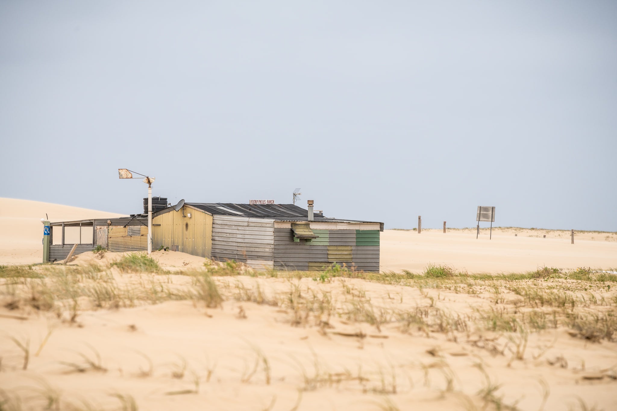 Back of the Ranch at Tin City, looking across some of the shoreline vegetation towards the ranch.
