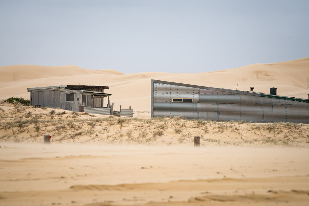 From The Beach at Tin City, two corrugated iron structures sit low against the dunes at Tin City, Stockton Beach.