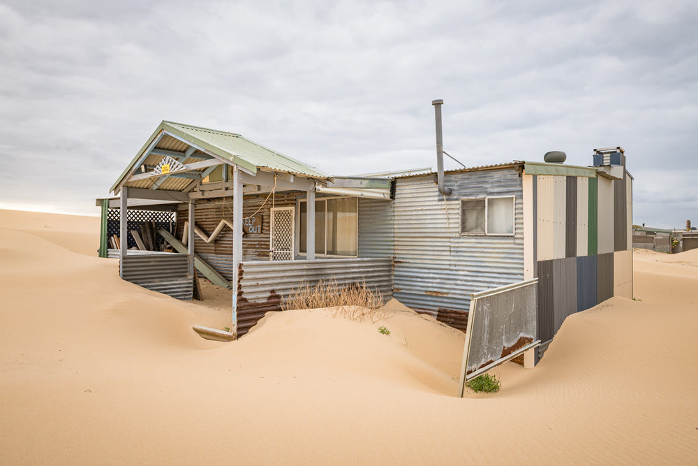 Front Yard at Tin City, the sand swept porch of one of the Tin City shacks.