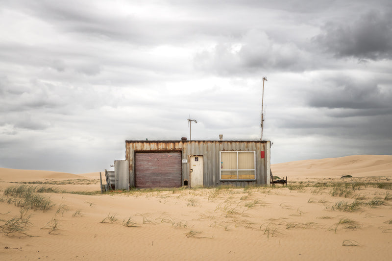 Seven at Tin City, shack number seven sits low against the dunes at Tin City, Stockton Beach.