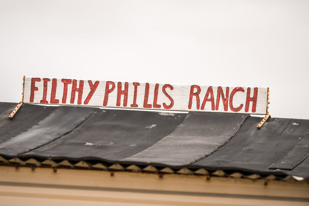 Signage at Tin City, a hand-painted sign sits bolted to the roofline.