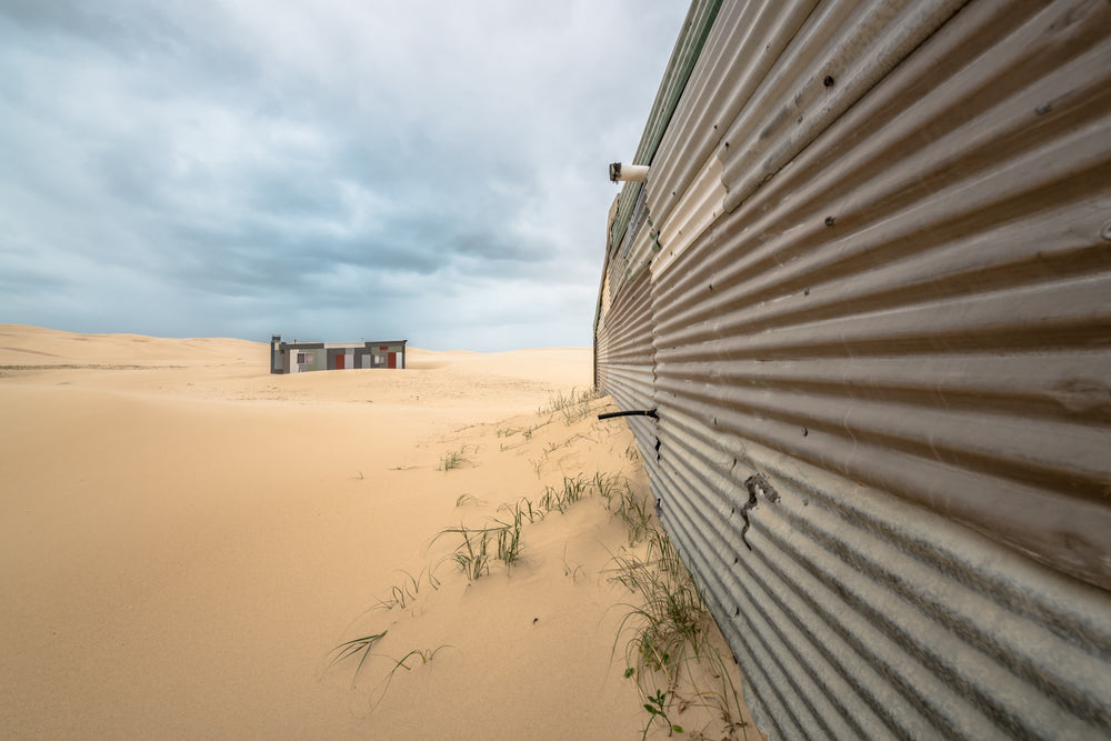 The Wall at Tin City, corrugated iron sheeting looking to a distant Tin City shack.
