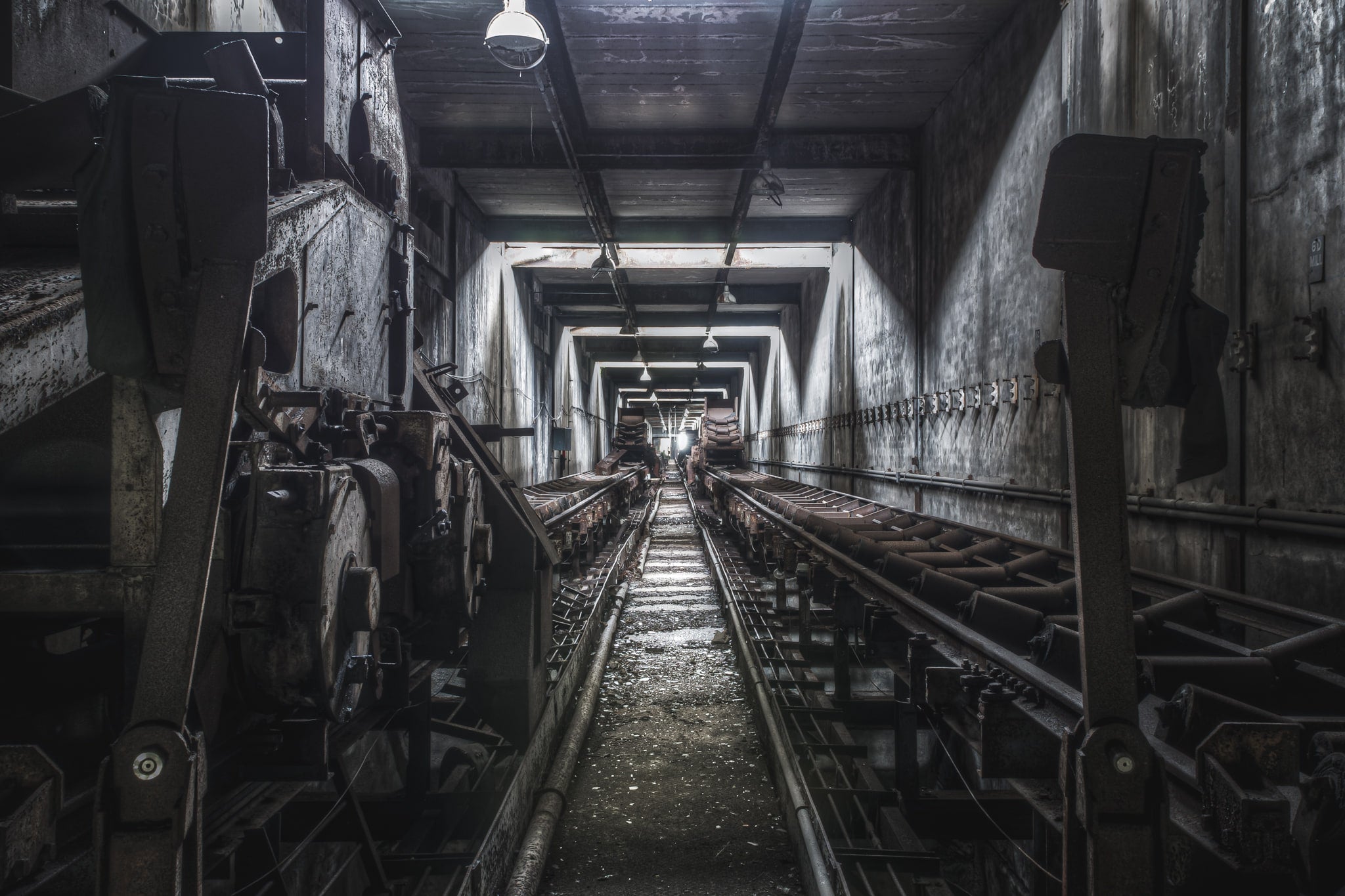 Bunker Conveyors at Wangi Power Station, a narrow corridor stretches deep between steel bunker walls.