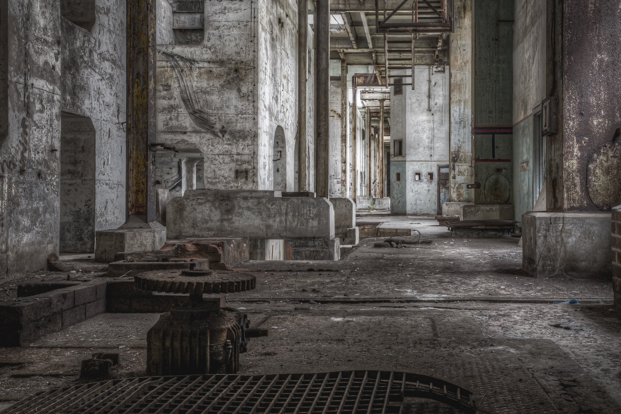 Condensation Extraction at Wangi Power Station, a heavy cast-iron gear assembly sits on the concrete floor, teeth thick.