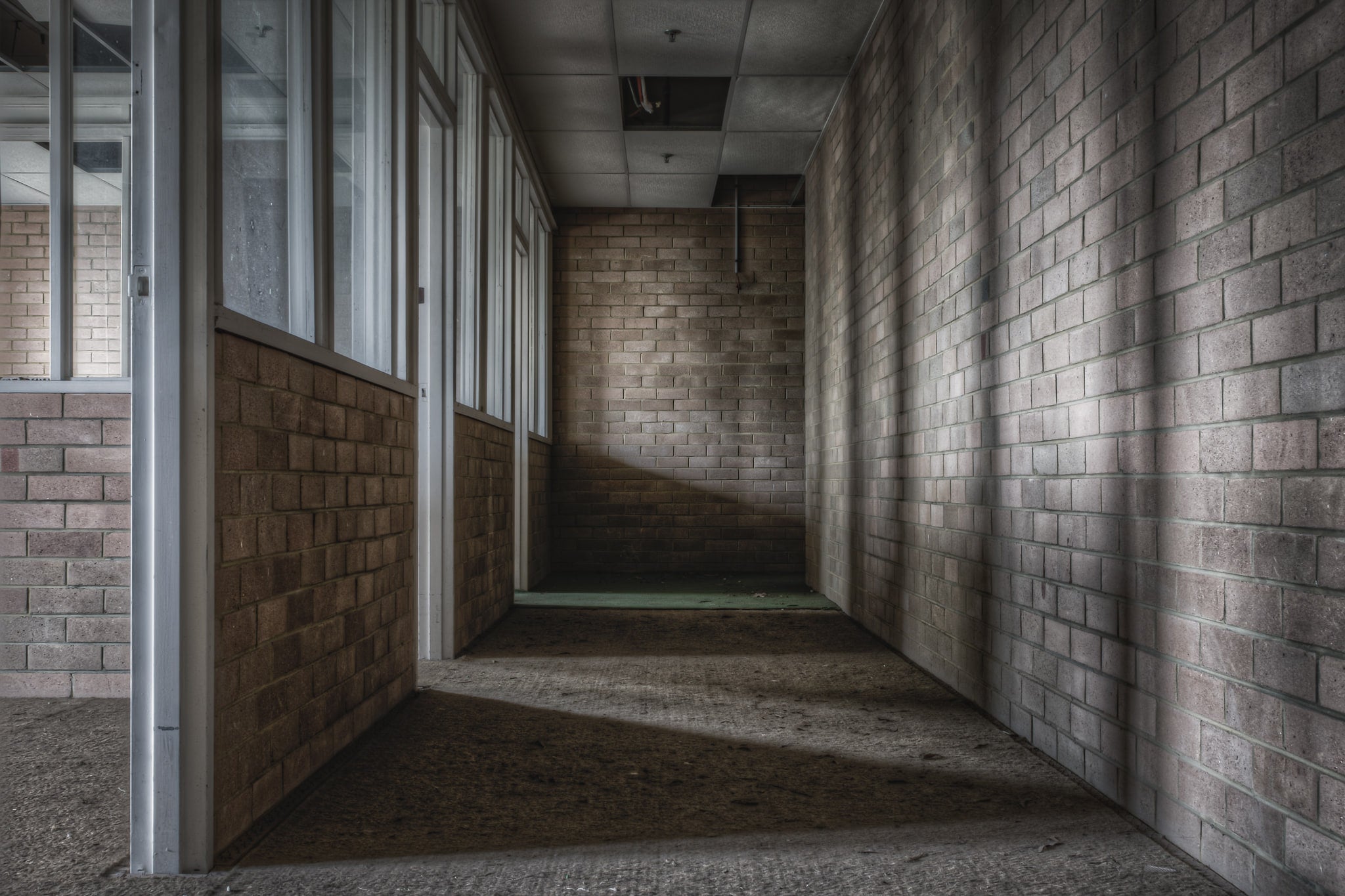 Engineers Office at Wangi Power Station, a narrow corridor of brown brick narrows toward a dead end.