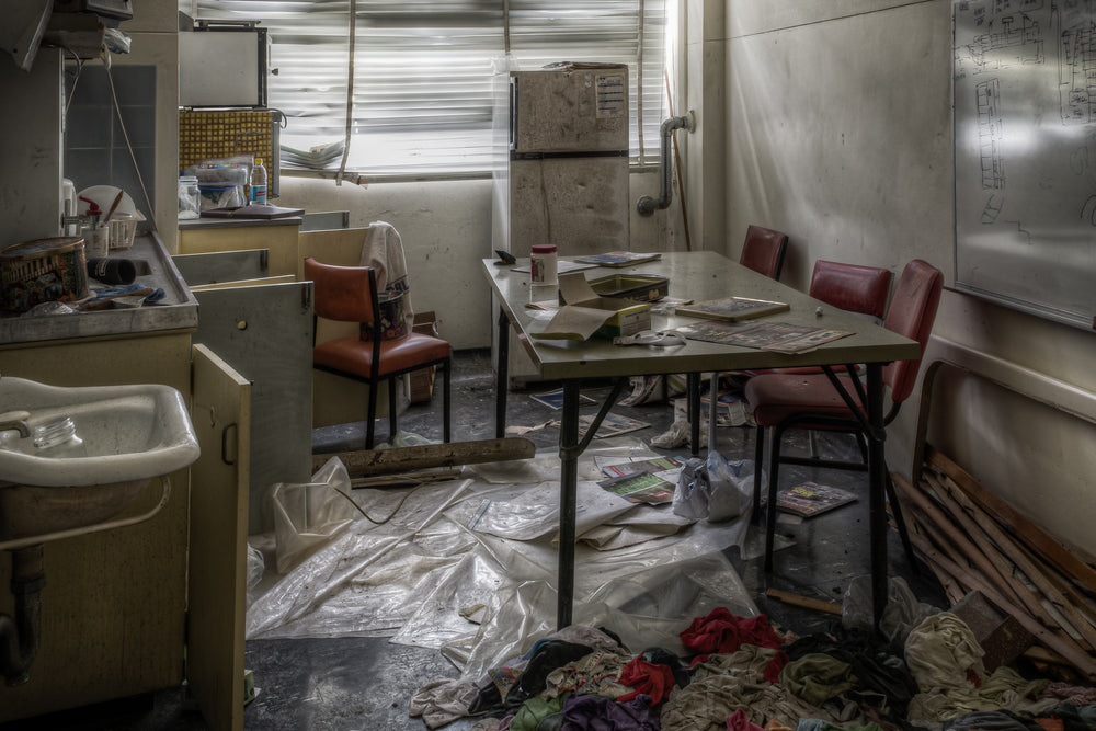 First Aid Centre Kitchen at Wangi Power Station, a steel-legged table sits centre of the room, surrounded by vinyl chairs.