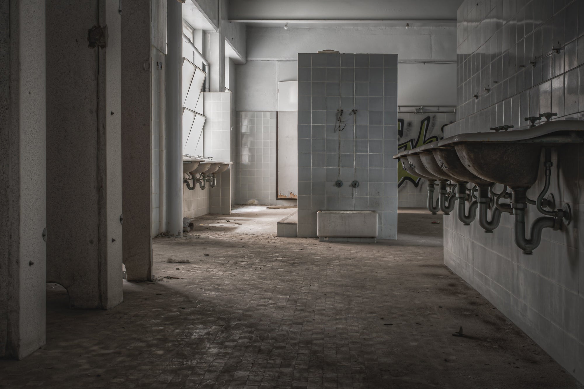 Main Bathroom at Wangi Power Station, white ceramic tiles line the walls from floor to ceiling.