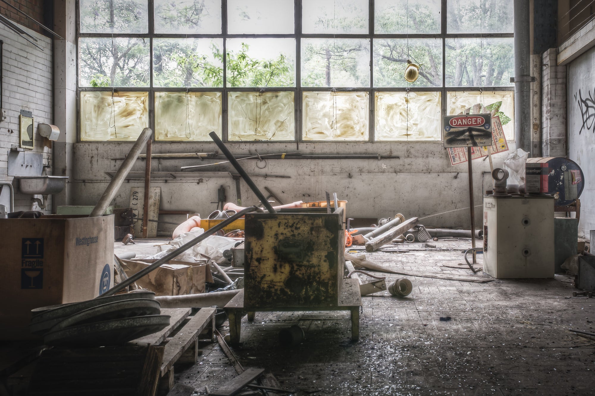 Plumbers Workshop at Wangi Power Station, a steel tool cabinet sits overturned on the concrete floor, its green paint.