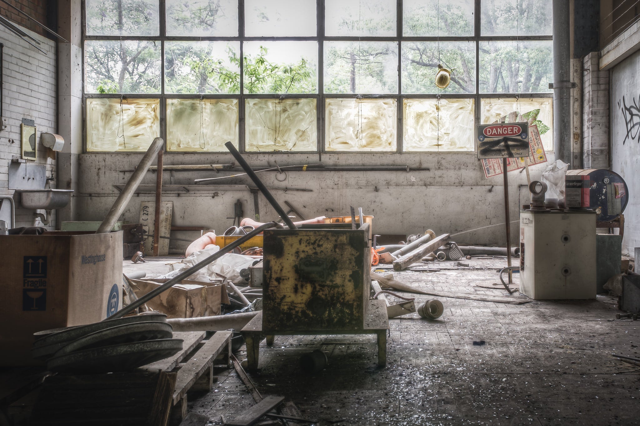 Plumbers Workshop at Wangi Power Station, a steel tool cabinet sits overturned on the concrete floor, its green paint.