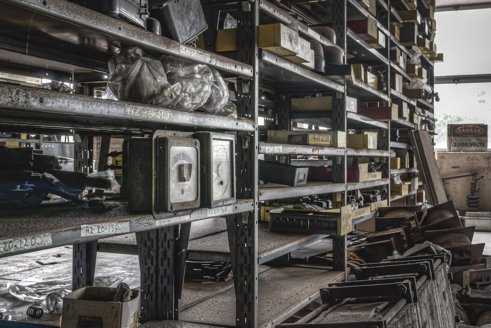 Spares Shelving at Wangi Power Station, steel parts shelving lines the stores room in tight rows, each shelf still loaded.