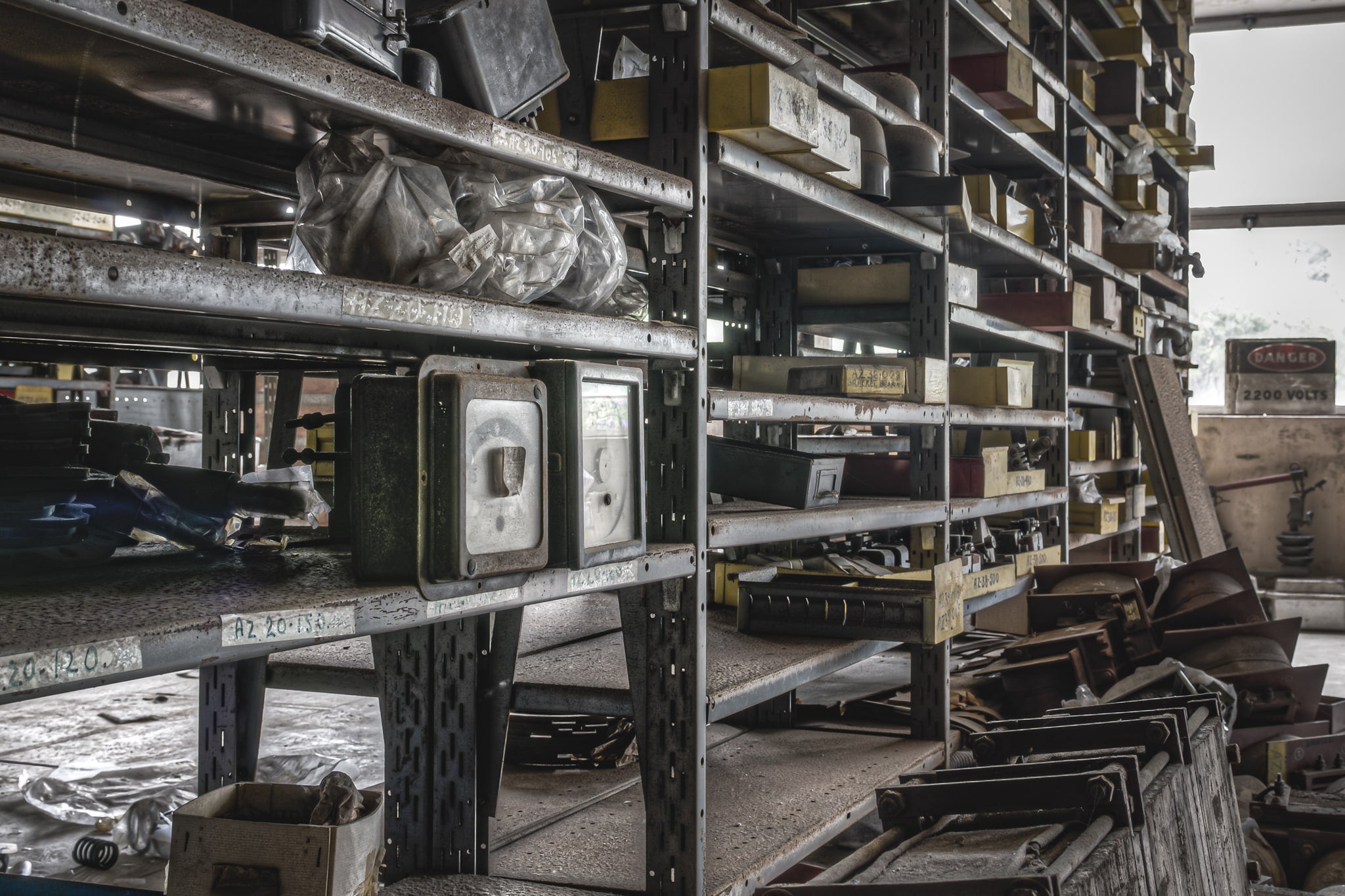 Spares Shelving at Wangi Power Station, steel parts shelving lines the stores room in tight rows, each shelf still loaded.
