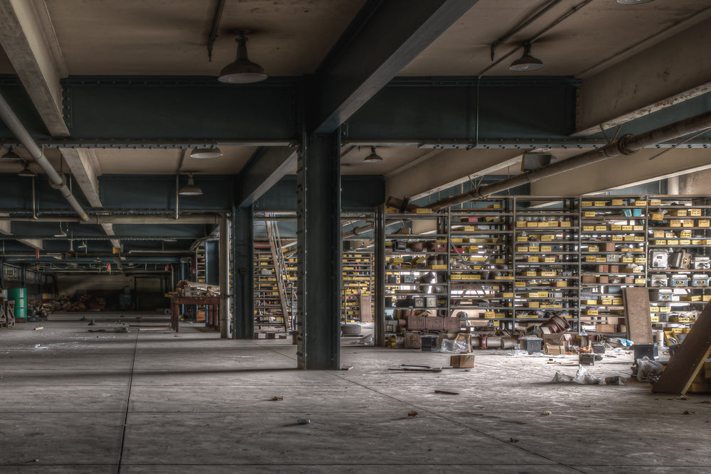 Store Roof 2 at Wangi Power Station, steel columns painted dark teal carry heavy I-beams across a low ceiling.