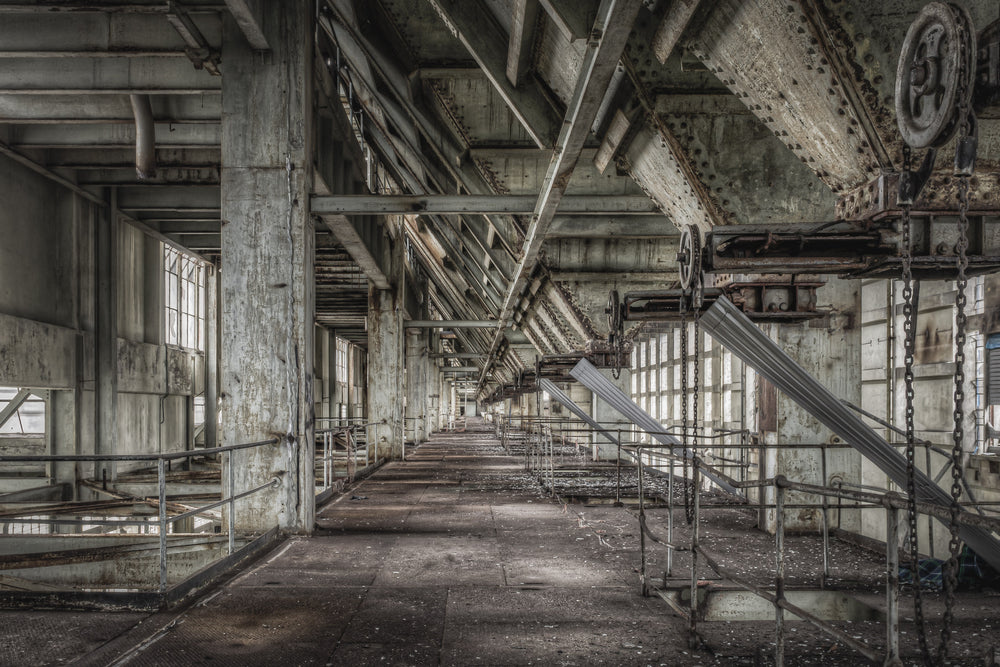 Weigher Floor at Wangi Power Station, a long concrete corridor stretches deep into the building, flanked by steel railings.