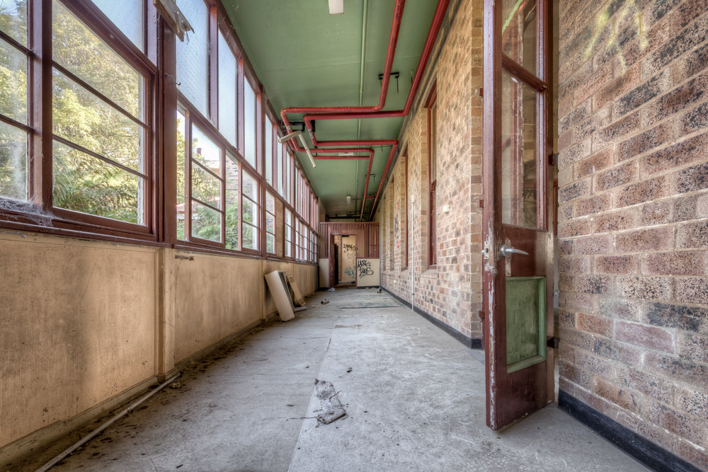 Annex at Waterfall Sanatorium, a long enclosed corridor runs between a brick ward building and a wall of timber-framed.
