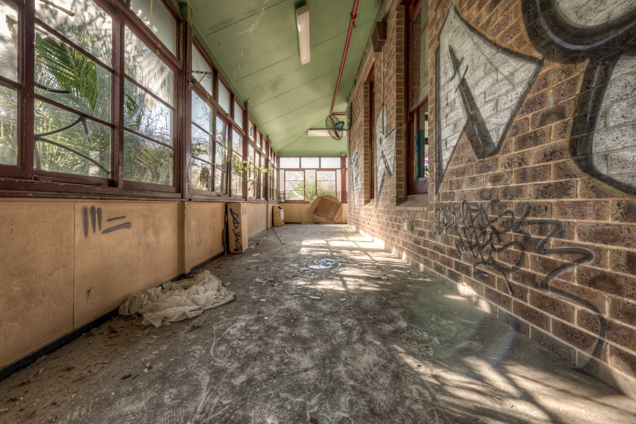 Brick Annex at Waterfall Sanatorium, a covered verandah runs along the brick annex, its pale green timber ceiling still.