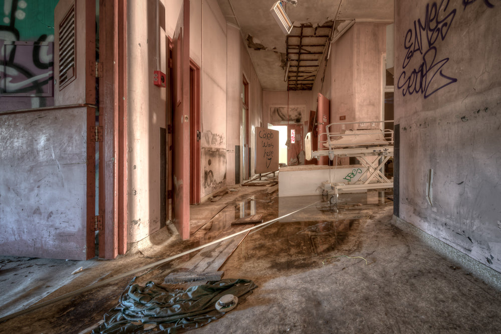 Caleb Was Here at Waterfall Sanatorium, a corridor runs deep into the ward.
