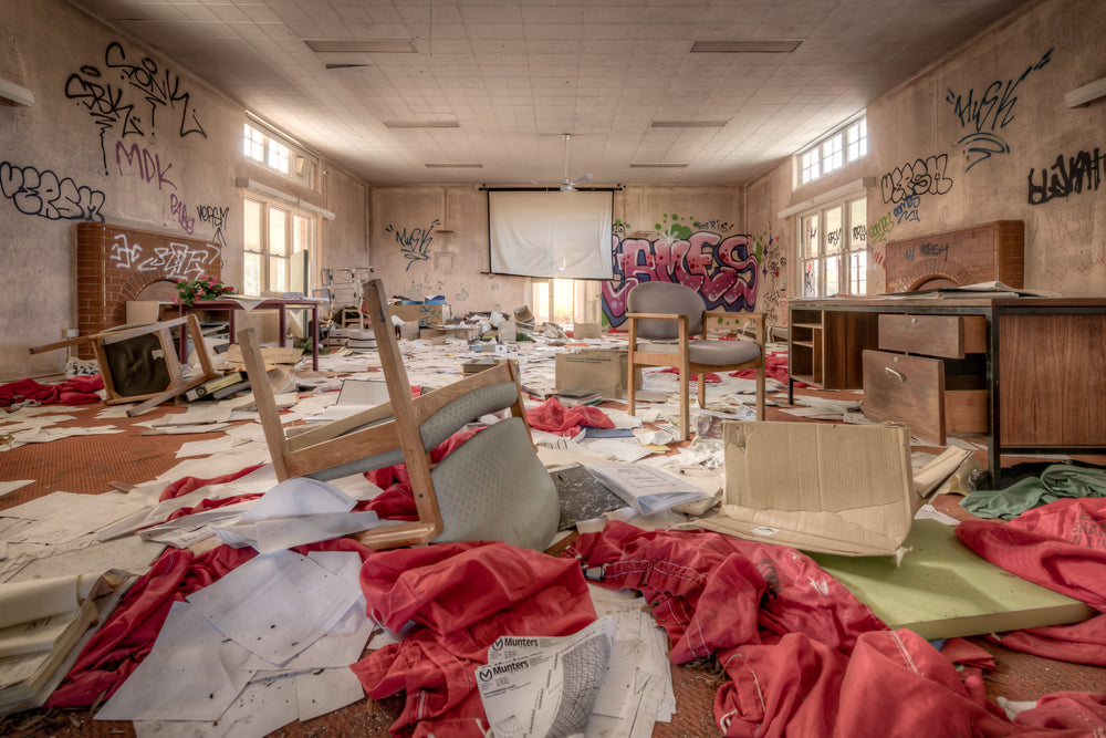The Document Room at Waterfall Sanatorium, patient documents, strewn across a heavily graffitied room with upturned.