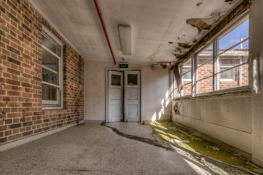 Exit Walkway at Waterfall Sanatorium, an external corridor tinged green closest to the window.