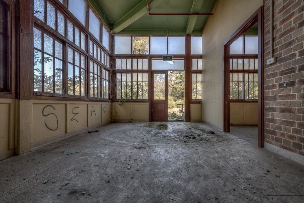 Glasshouse at Waterfall Sanatorium, frosted glass panels fill the walls from dado rail to ceiling, framed in dark timber.