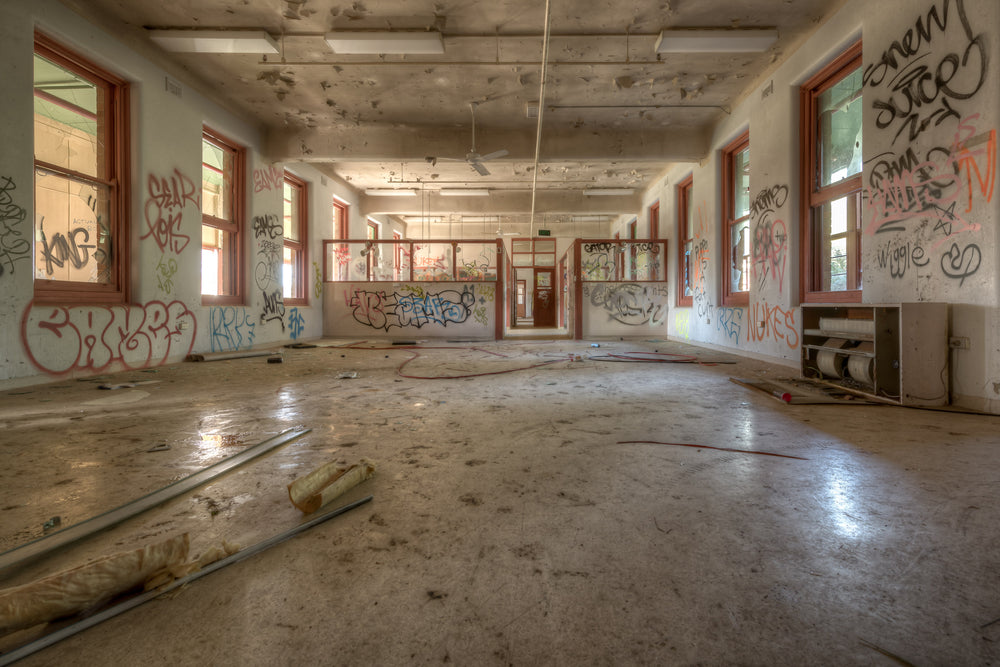 Looking Down The Ward at Waterfall Sanatorium, a long open room stretches back toward a partitioned doorway.