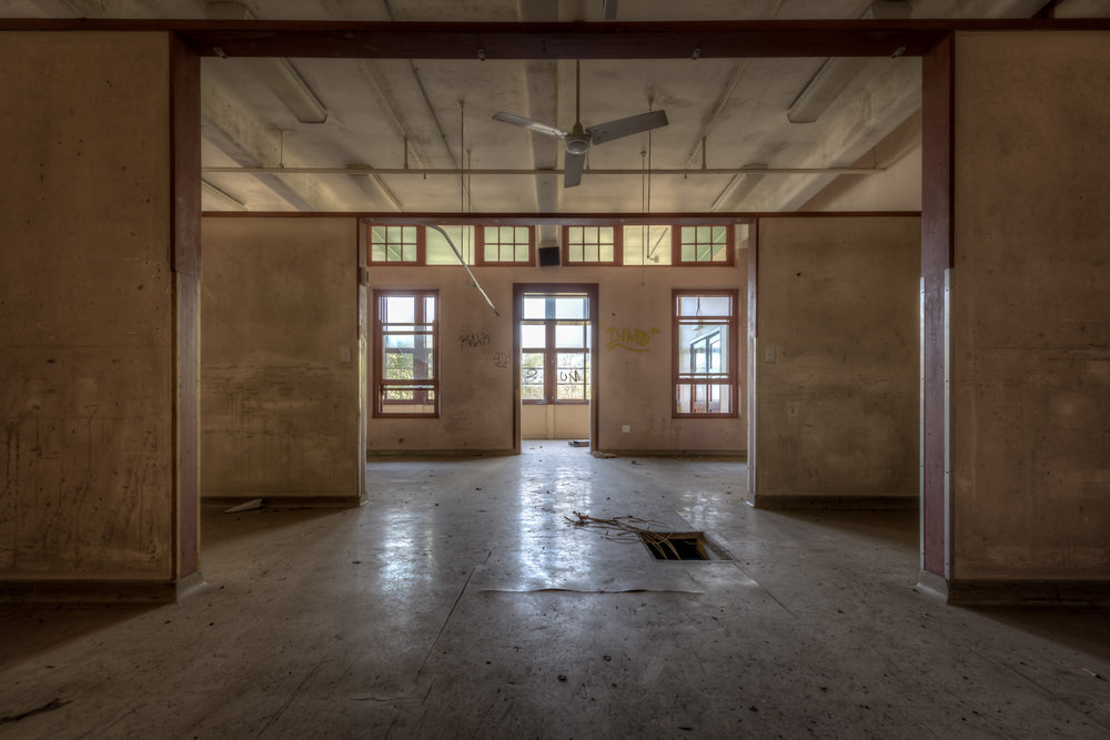 Squares In Squares at Waterfall Sanatorium, timber posts frame a sequence of open rooms, each threshold leading deeper.