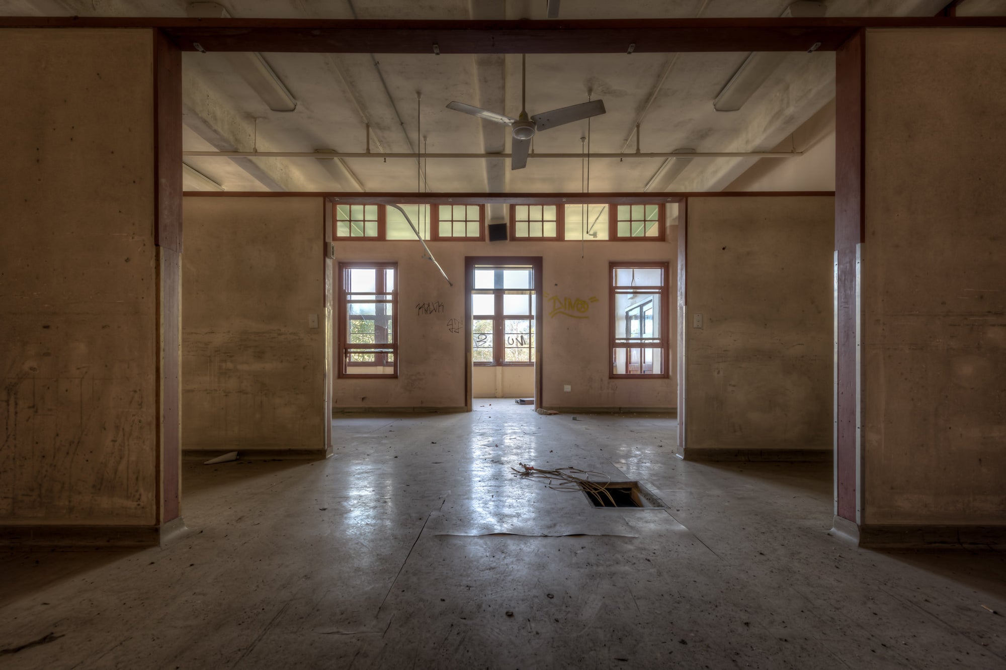 Squares In Squares at Waterfall Sanatorium, timber posts frame a sequence of open rooms, each threshold leading deeper.