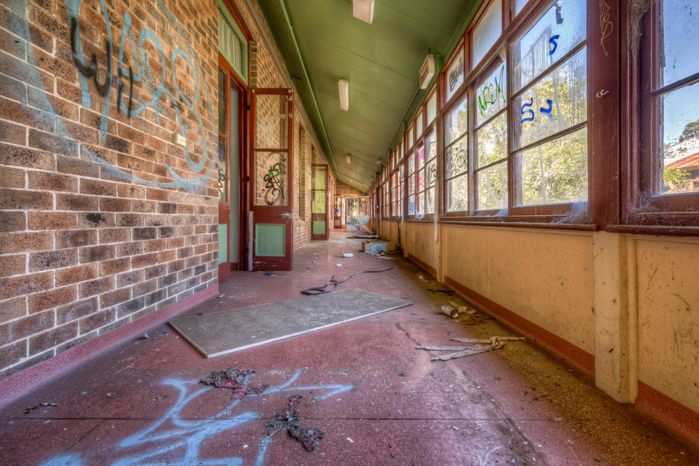 The Long Walk at Waterfall Sanatorium, a covered verandah runs deep into the building, narrowing to a vanishing point.