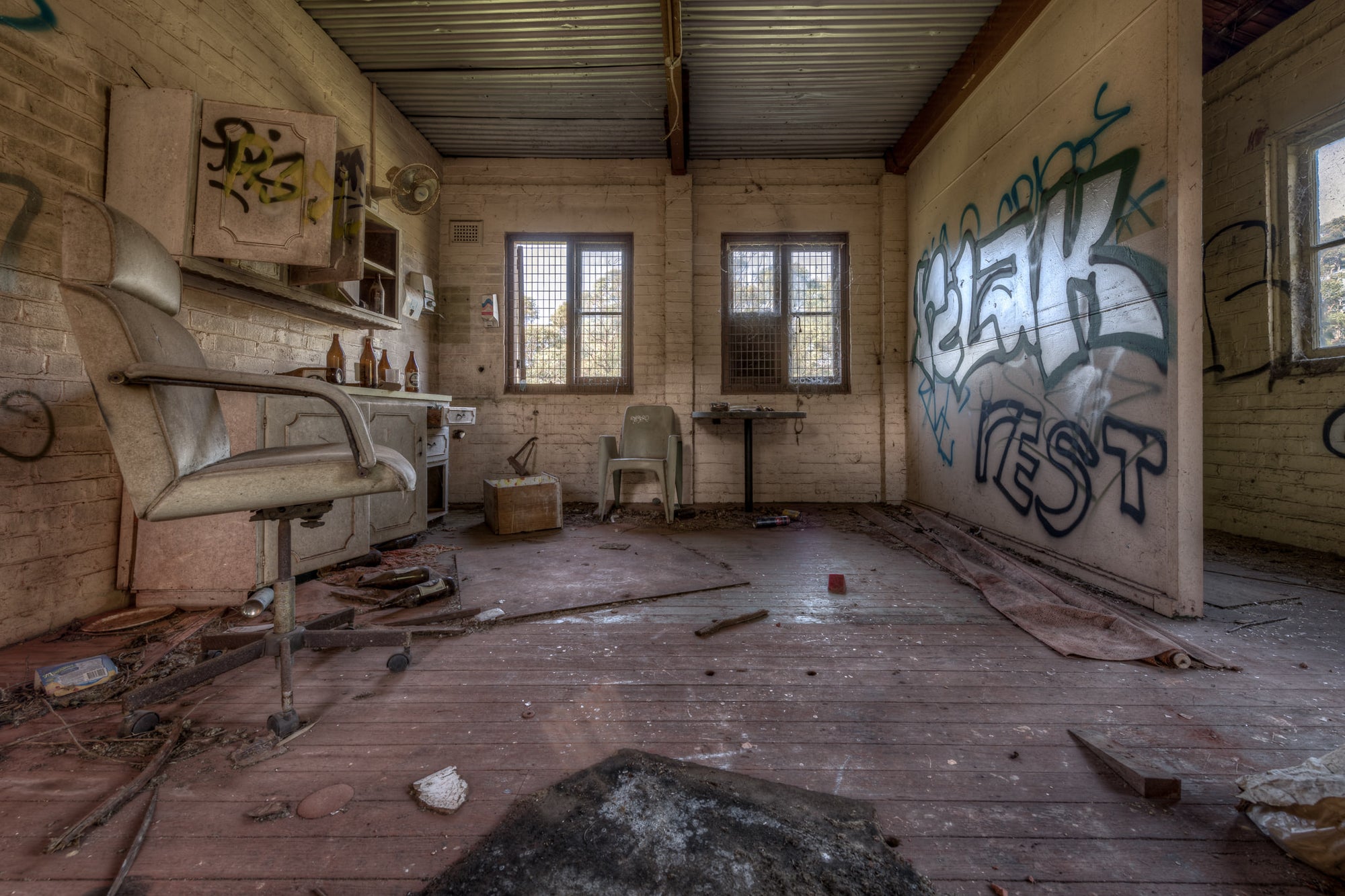 The Shed at Waterfall Sanatorium, a cream brick room with a corrugated iron ceiling.