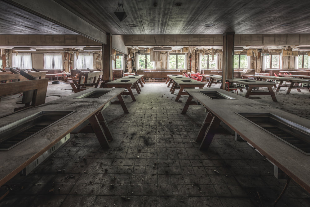Hot Plate Tables at Western Village, rows of heavy timber-framed tables fill a low-ceilinged dining hall.