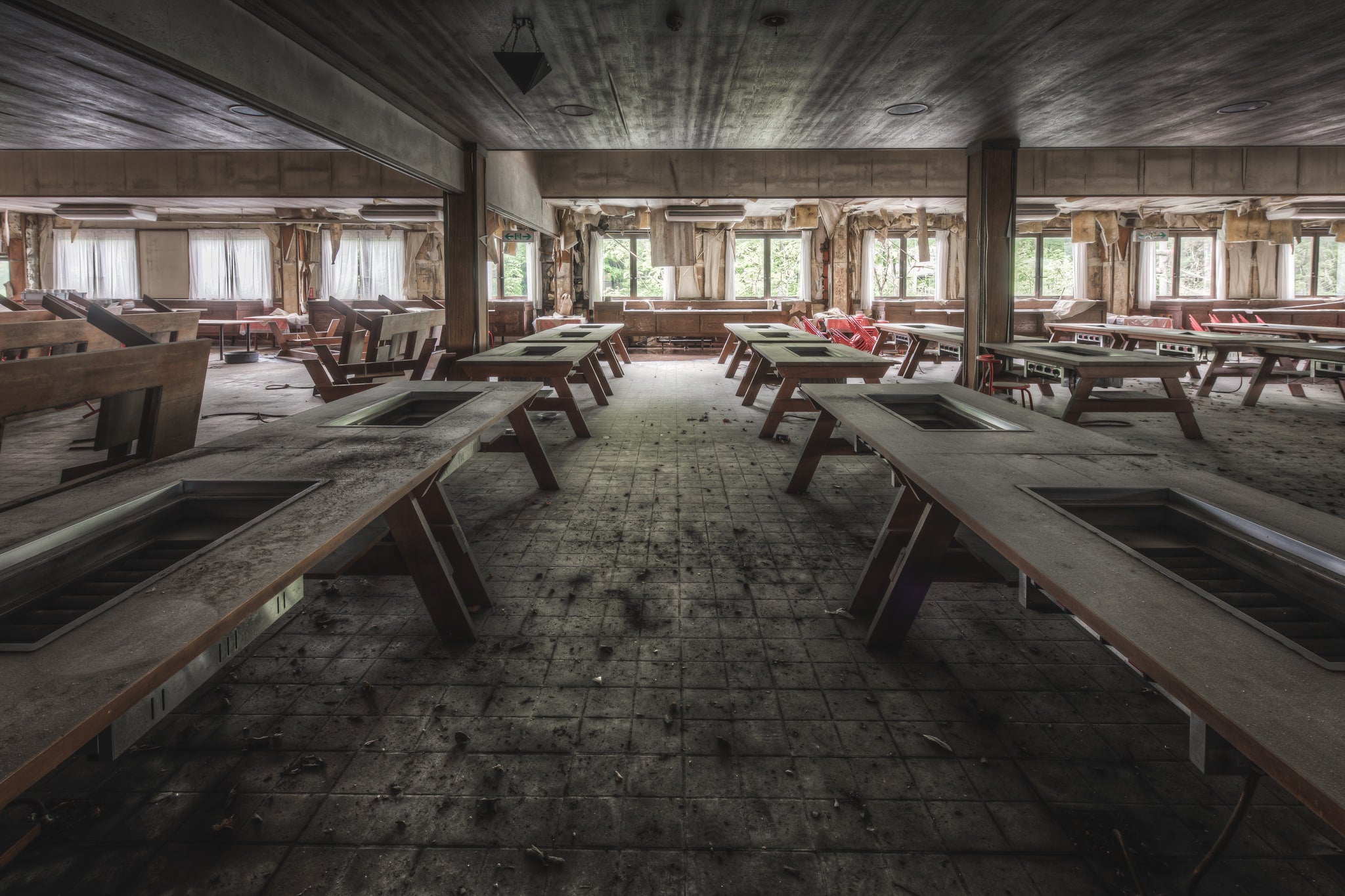 Hot Plate Tables at Western Village, rows of heavy timber-framed tables fill a low-ceilinged dining hall.