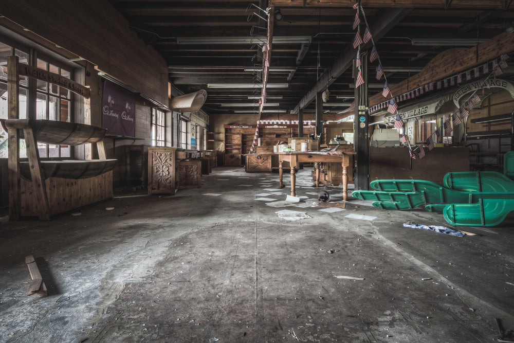 Souvineer Shop at Western Village, american flags hang limp from timber beams above a wide concrete floor.