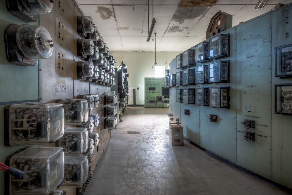 Ammeter Wall at White Bay Power Station, rows of glass-cased ammeters and relay instruments line both walls of a narrow.