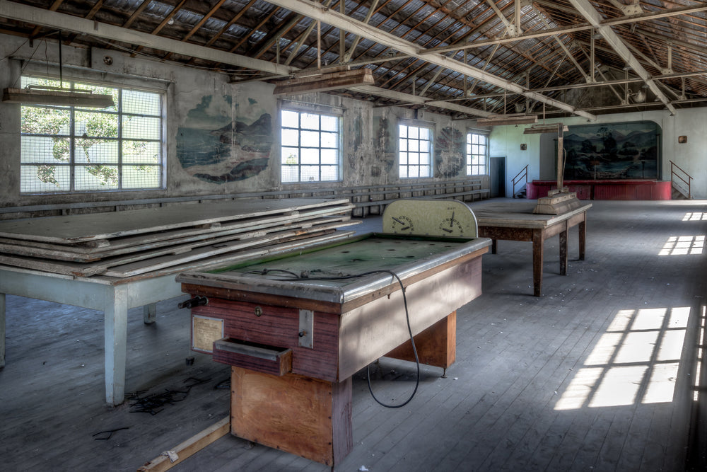 Bar Billiards at White Bay Power Station, a coin-operated bar billiards table sits on worn timber floorboards, its green.