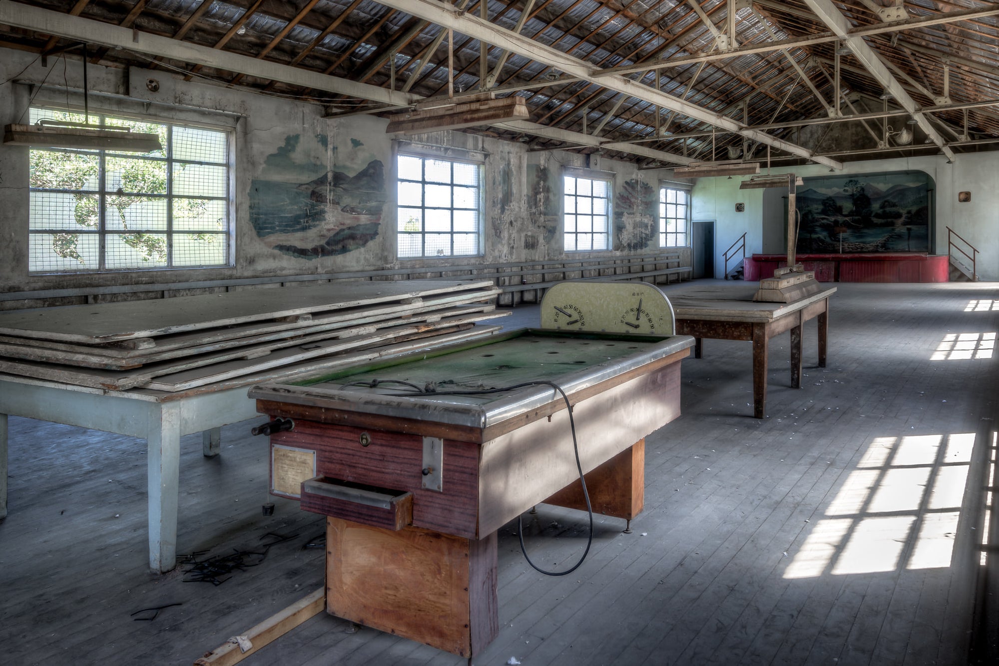 Bar Billiards at White Bay Power Station, a coin-operated bar billiards table sits on worn timber floorboards, its green.