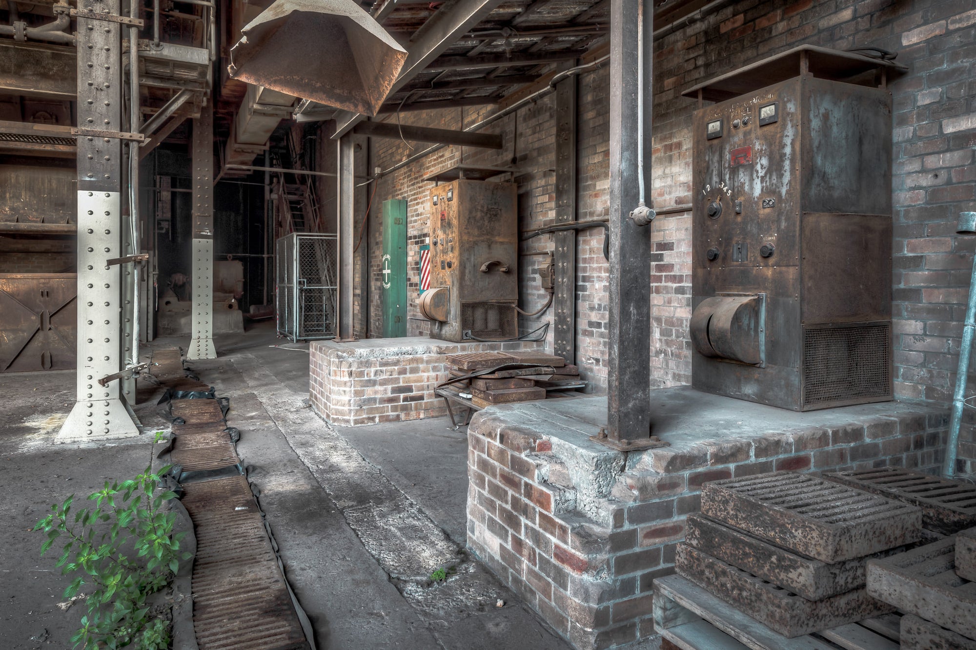 Controllers at White Bay Power Station, two rusted control units stand silent on their brick and concrete foundations.