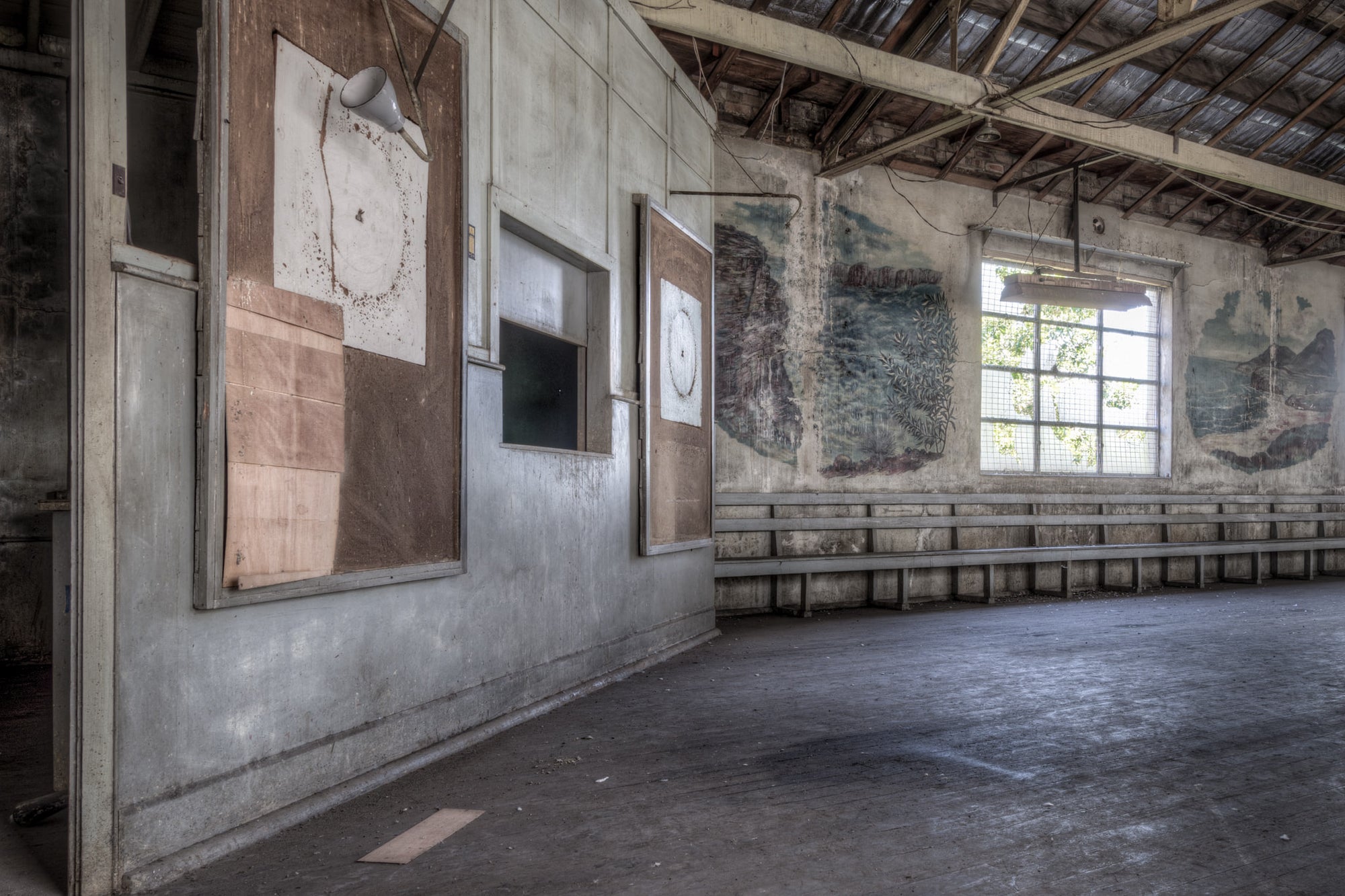 Dart Boards at White Bay Power Station, faint outlines mark where dartboards once hung, the surrounding walls pockmarked.