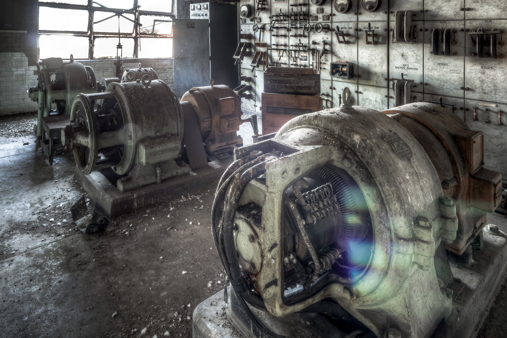 Generators And Knife Switches at White Bay Power Station, three generators sit bolted to concrete plinths, their cast-iron.