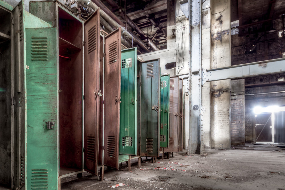 Lockers at White Bay Power Station, steel lockers line a concrete wall, doors hanging open.