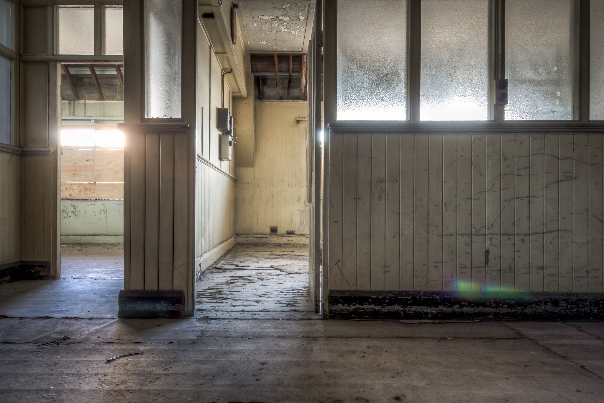 Offices at White Bay Power Station, frosted glass panels line the partition wall, their surface clouded with grime.