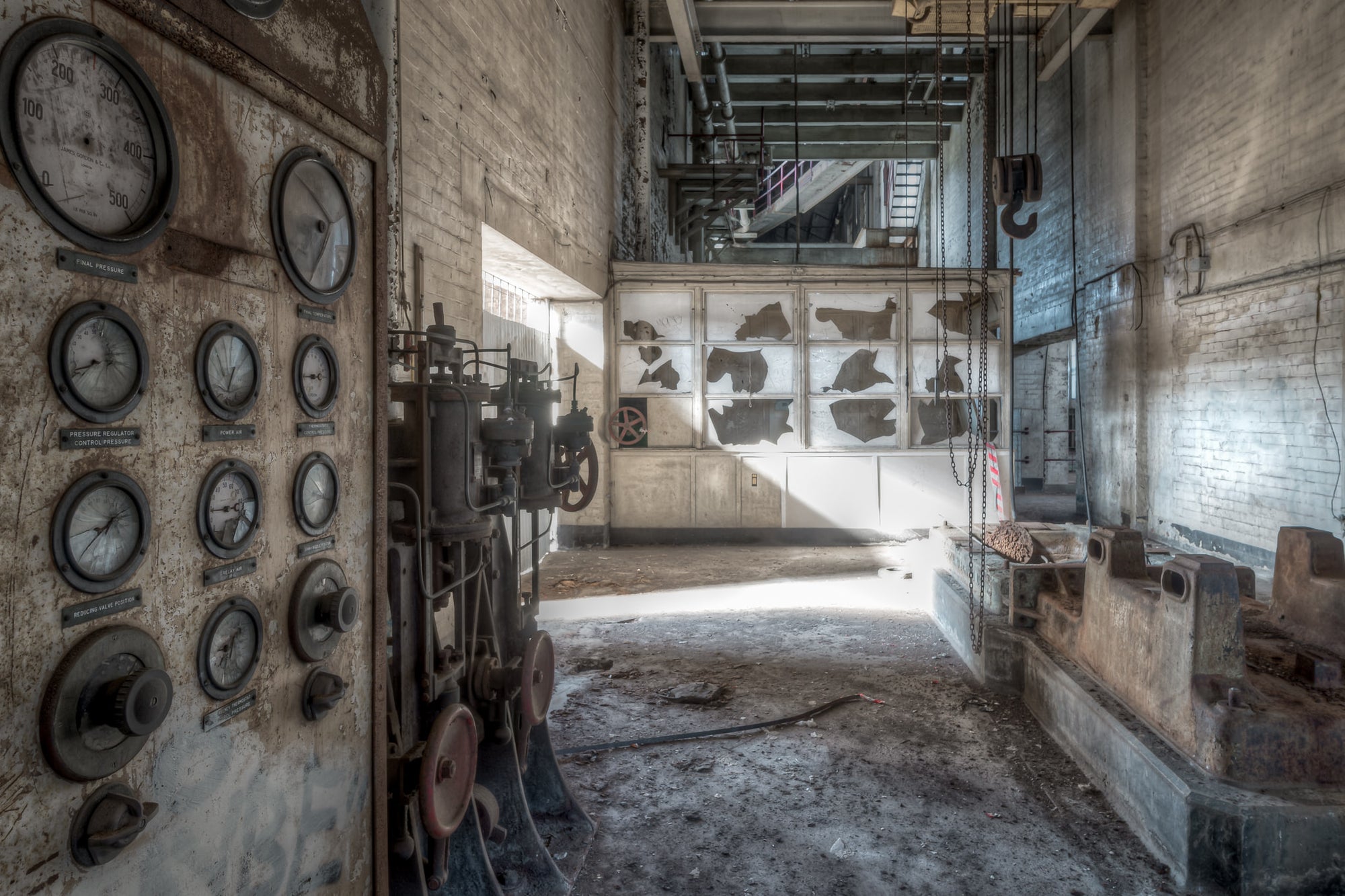 Pump House Equipment and Panel at White Bay Power Station, the rusted panel still holds its cracked gauges, their needles.