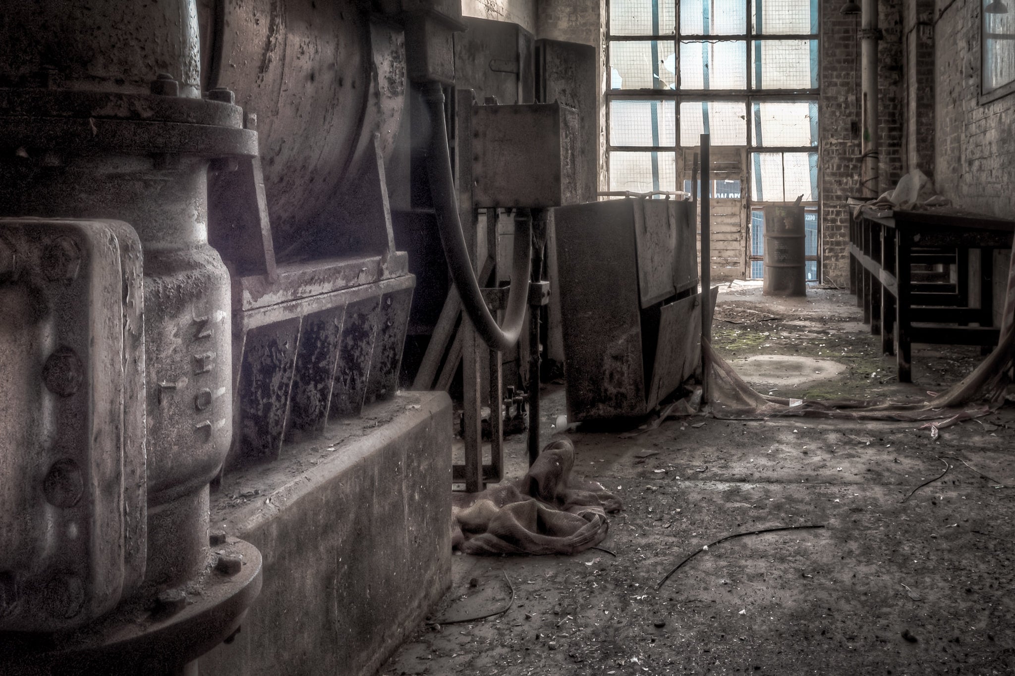 Pump at White Bay Power Station, a heavy cast-iron pump sits on a concrete plinth, its flanged casing thick with corrosion.