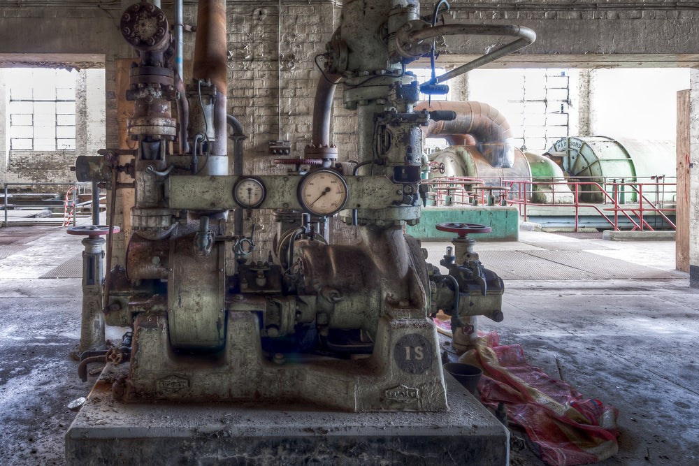 Steam Compressor at White Bay Power Station, a cast-iron steam pump sits bolted to its concrete plinth on the turbine hall.
