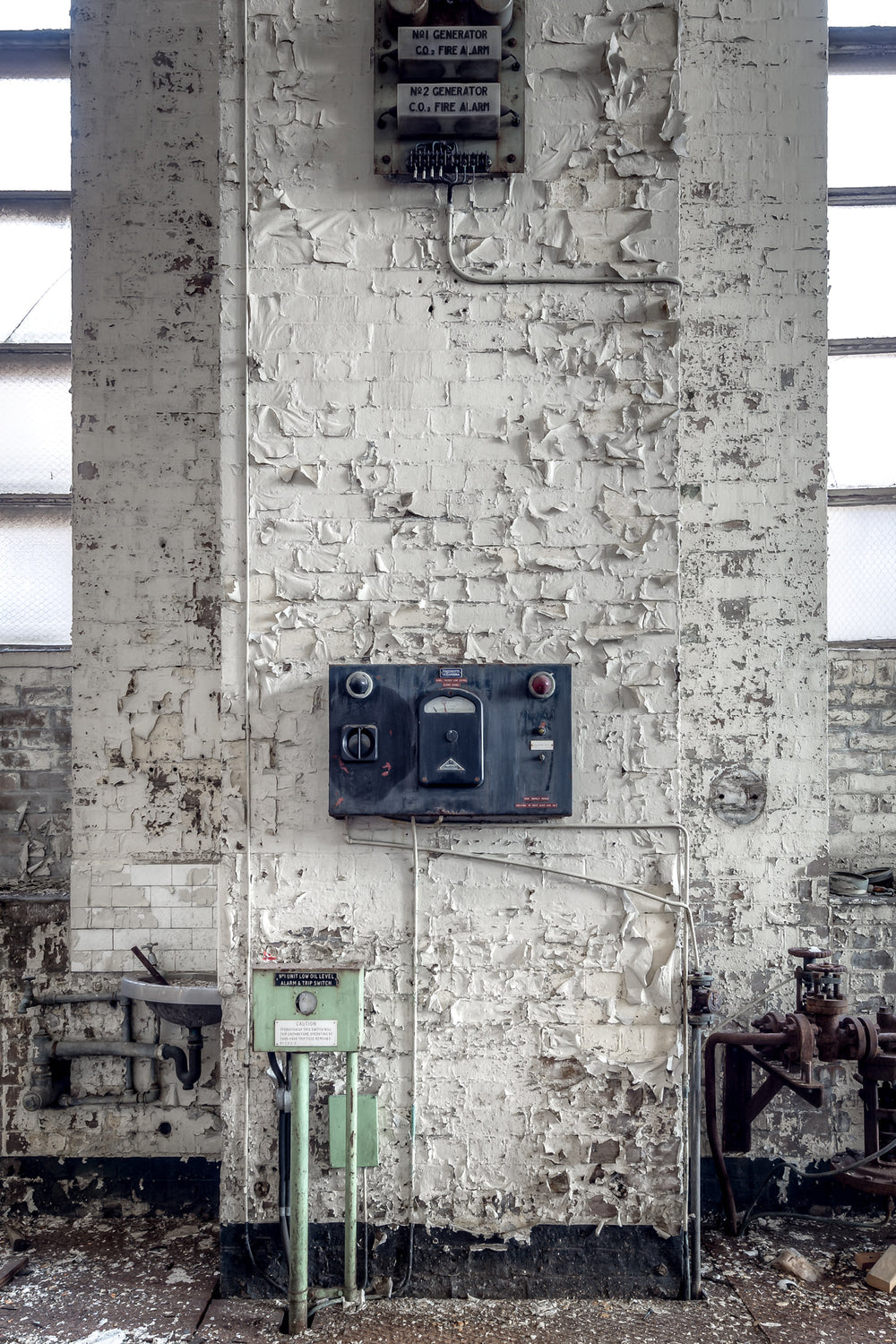 Turbine Hall Alarms at White Bay Power Station, a white-painted brick column rises between tall industrial windows.