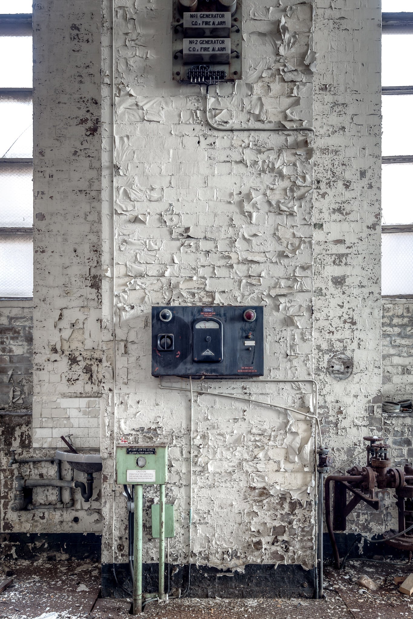 Turbine Hall Alarms at White Bay Power Station, a white-painted brick column rises between tall industrial windows.