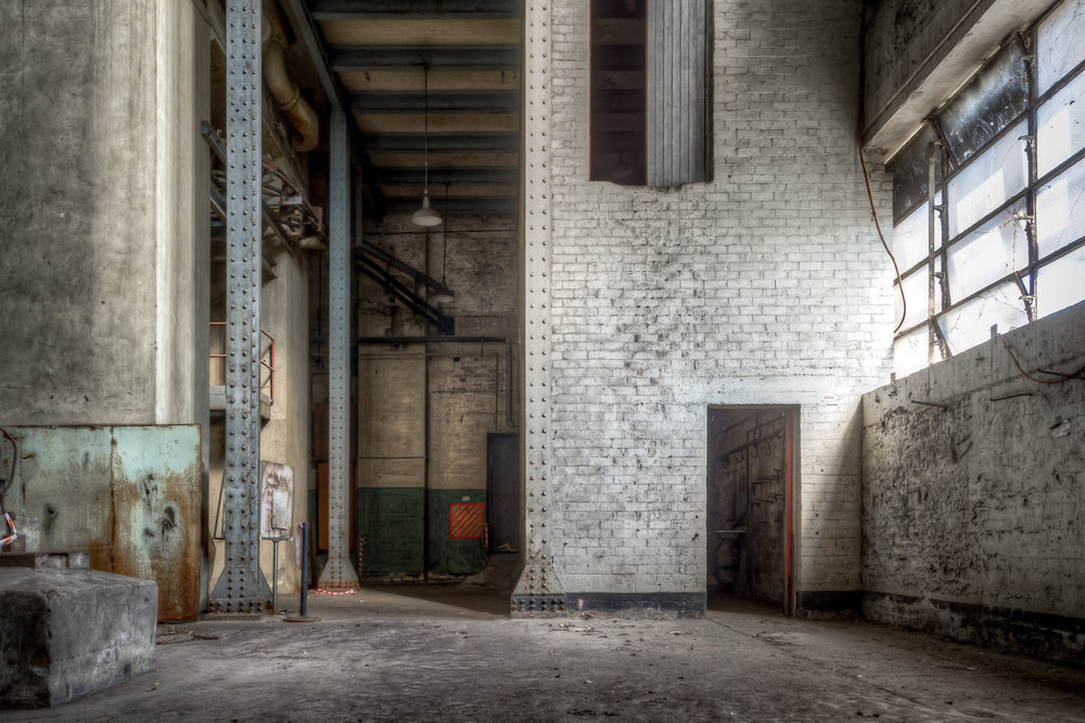 Turbine Hall Basement North End at White Bay Power Station, white-painted brick rises two storeys to meet riveted steel.