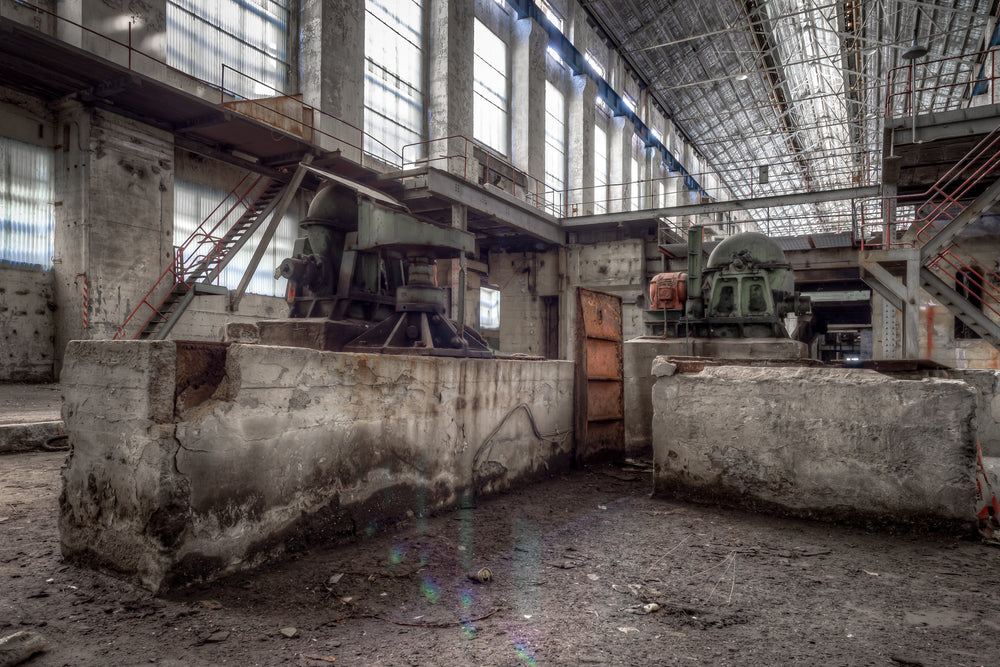 Turbine Hall Basement Northern End at White Bay Power Station, concrete plinths rise from the dirt floor at the northern.