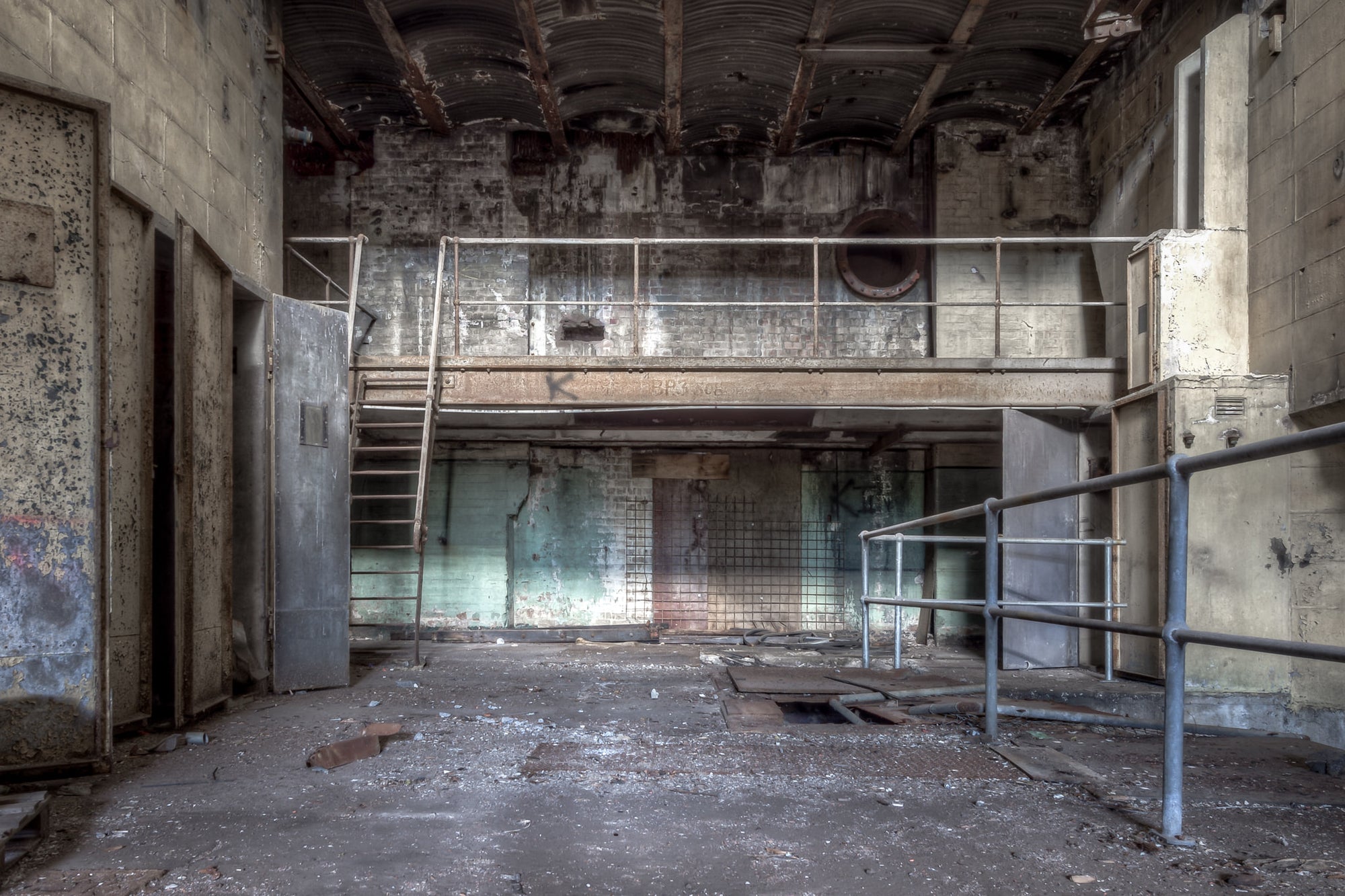 Turbine Hall Basement Storage at White Bay Power Station, a steel mezzanine walkway spans the rear wall, reached.