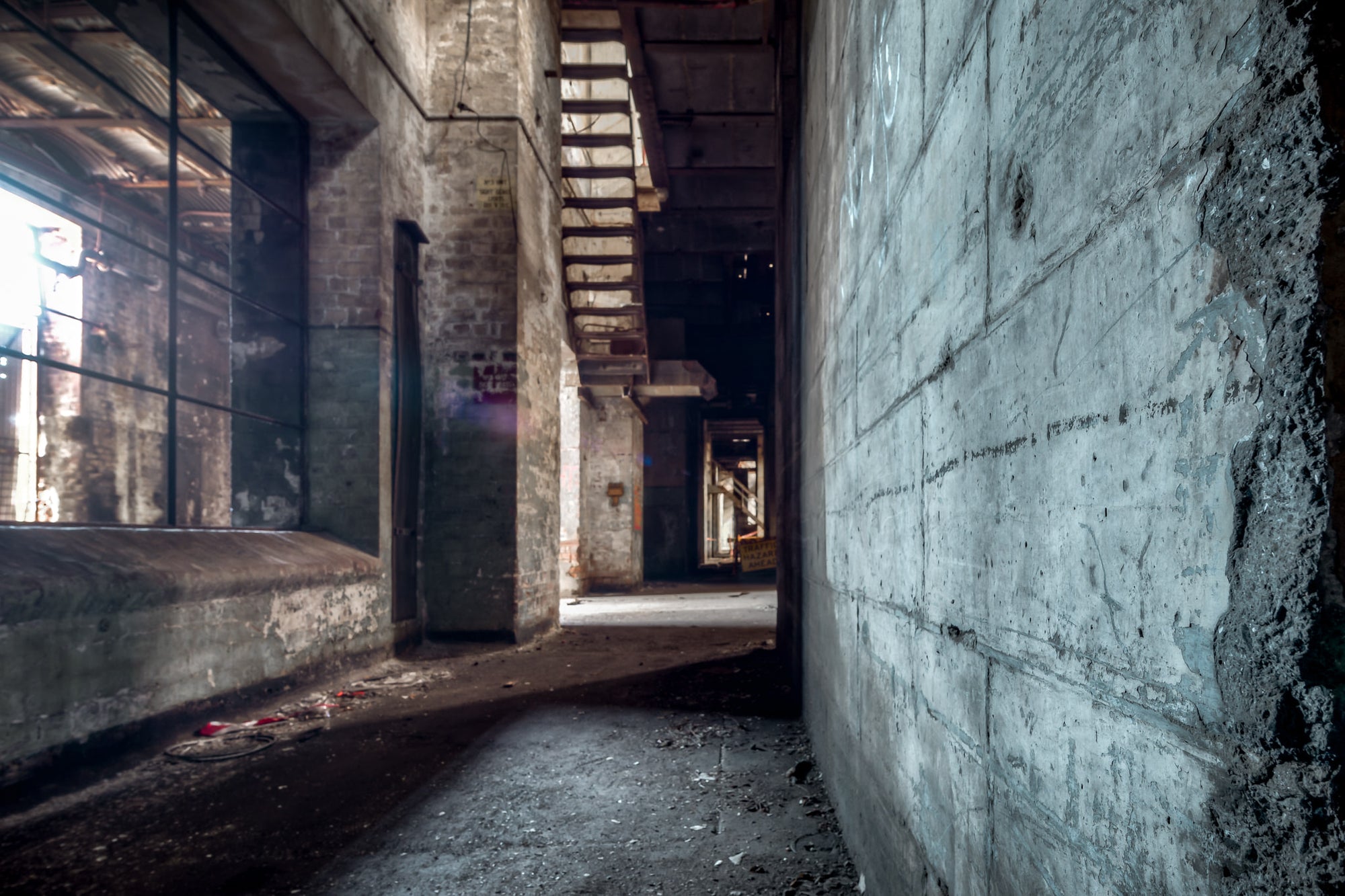 Turbine Hall Corridor at White Bay Power Station, a narrow corridor runs between poured concrete and exposed brick beneath.