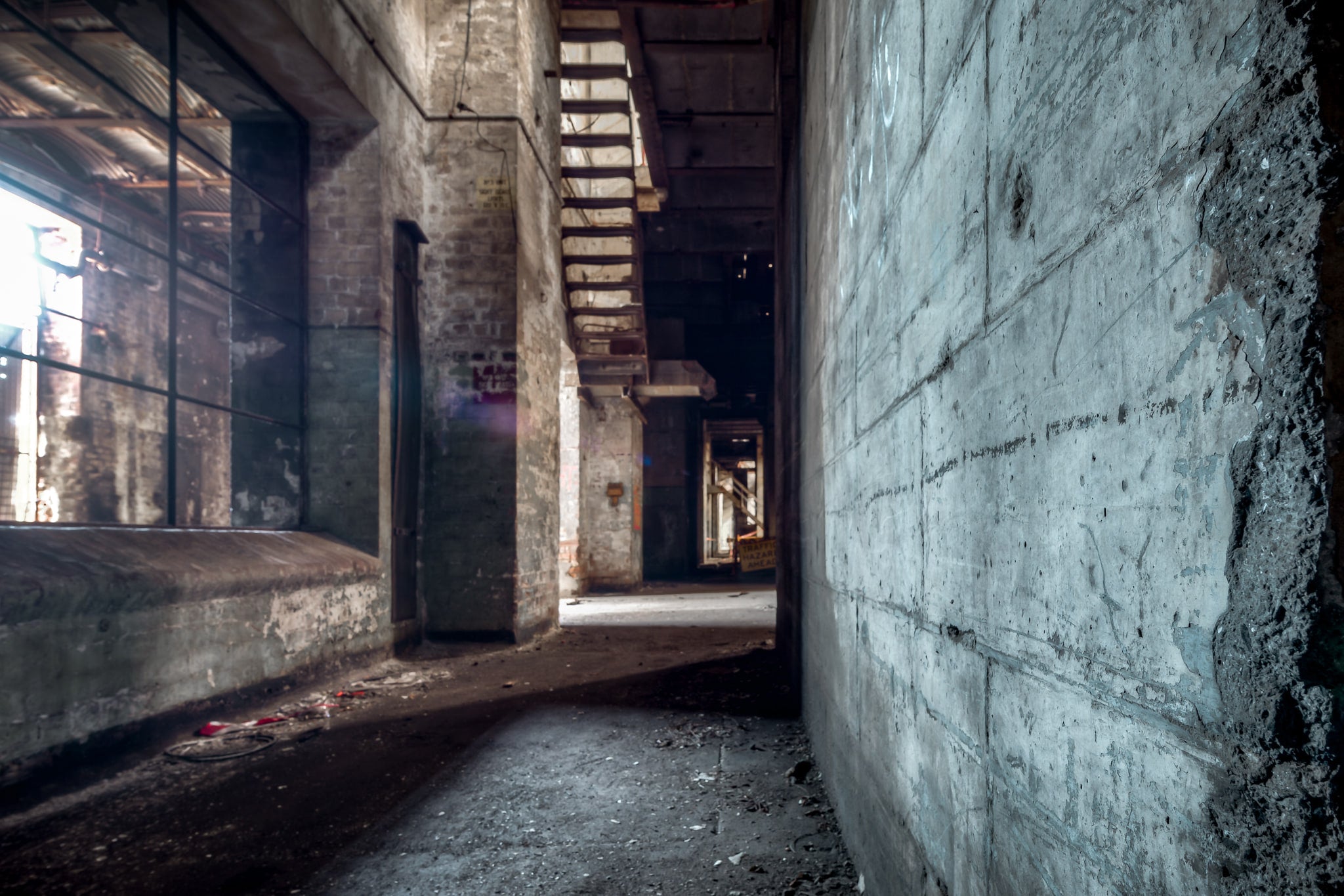 Turbine Hall Corridor at White Bay Power Station, a narrow corridor runs between poured concrete and exposed brick beneath.