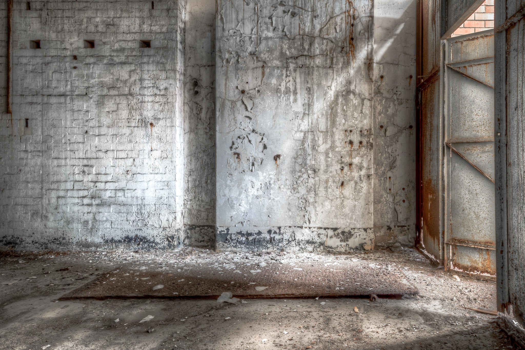 Turbine Hall Storage Room at White Bay Power Station, light filters through the rusted steel door of White Bay Power Station.